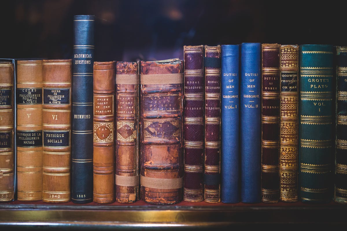 Classic leather-bound books on a wooden bookshelf - representing the publishing tradition behind Chicago Manual of Style