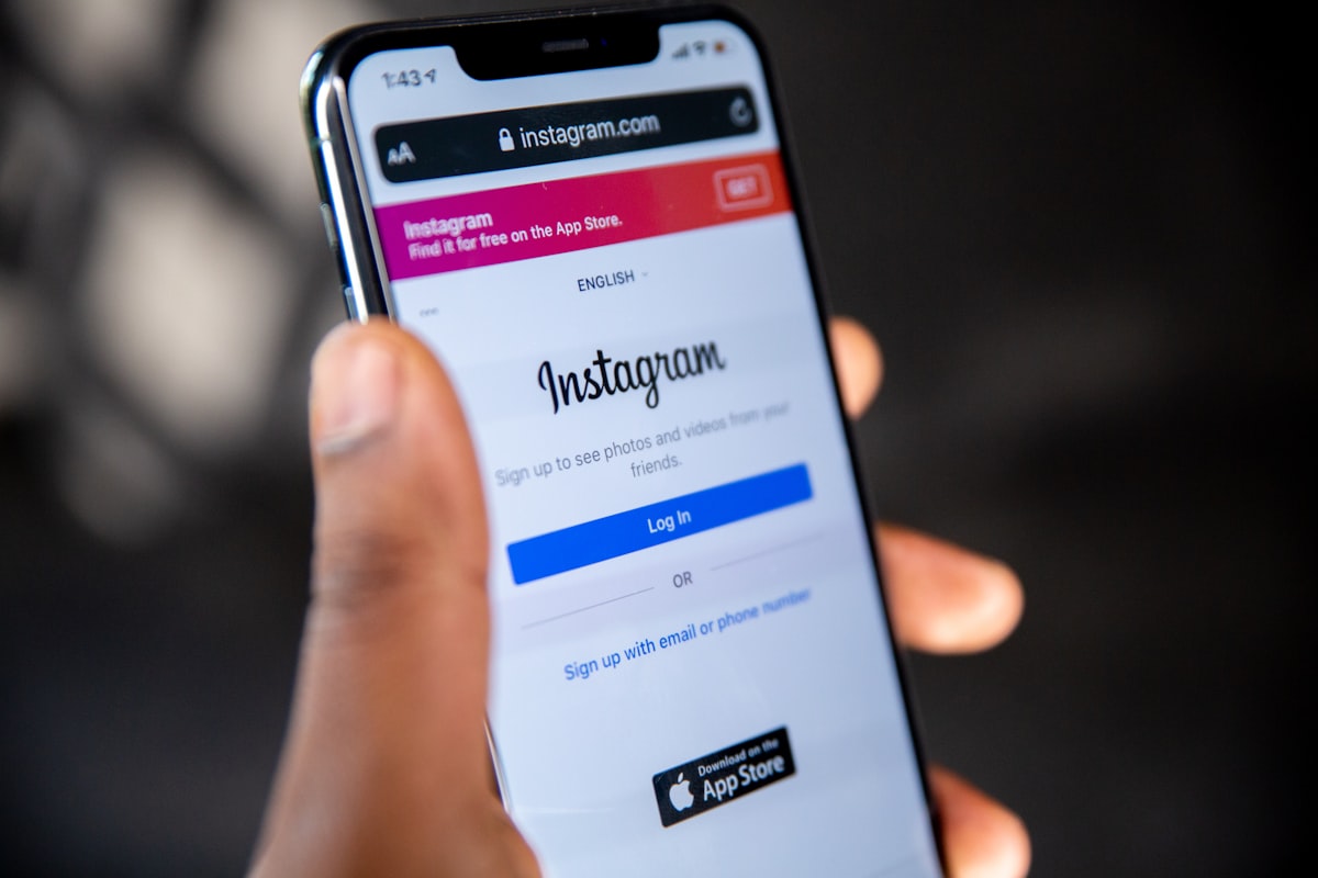 Person holding smartphone with Instagram app open showing captions and posts