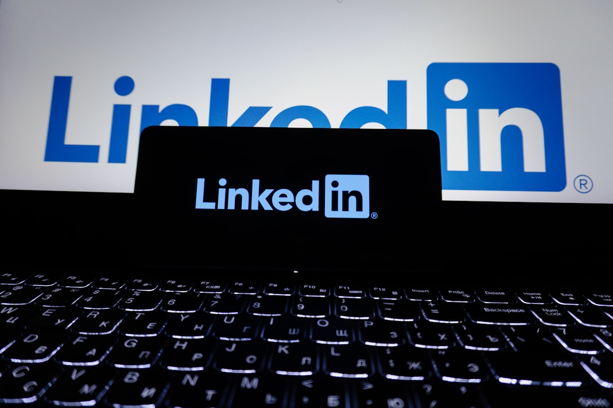 LinkedIn logo displayed on a laptop screen in a professional workspace