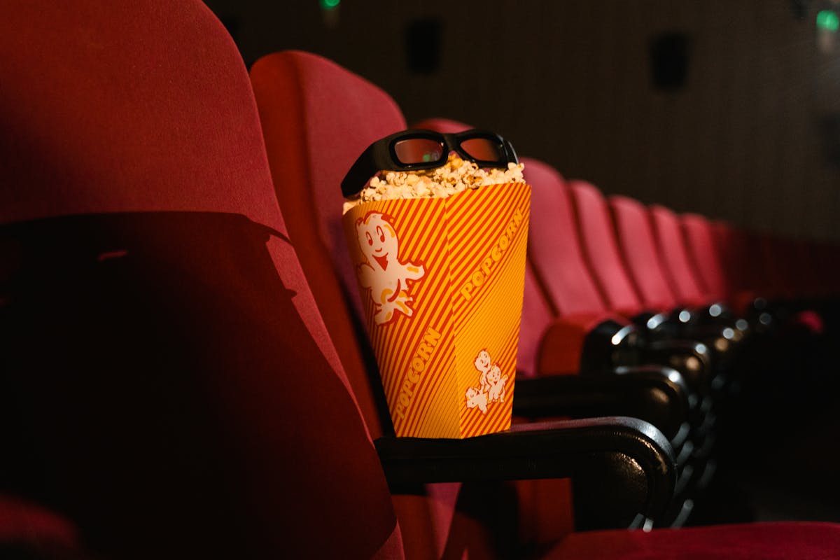 A cinema seat with popcorn and 3D glasses capturing the movie theater experience