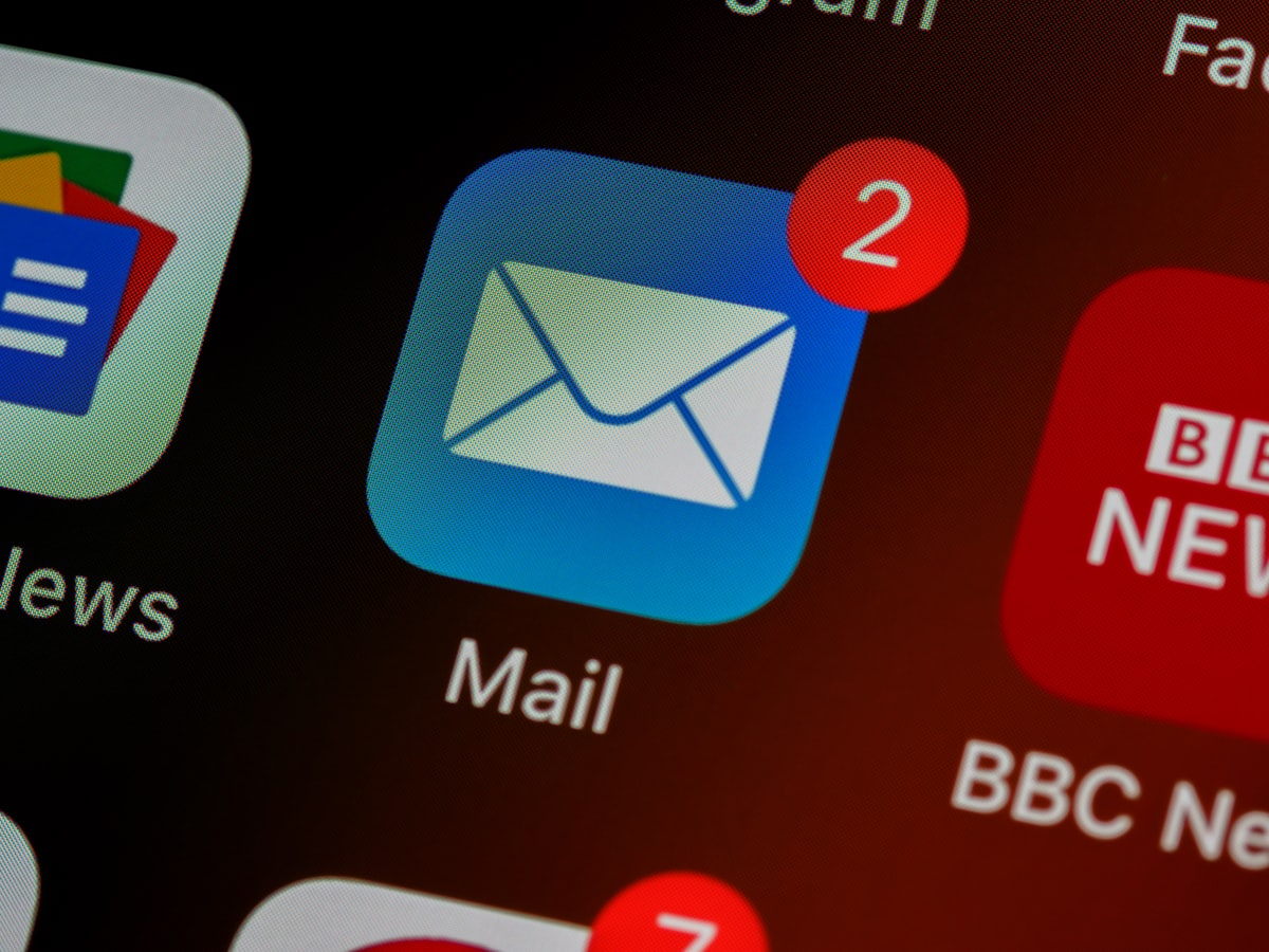 Closeup of a mail app icon on a phone screen showing unread newsletter notifications